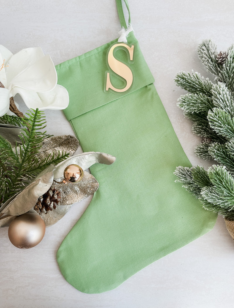 Linen Christmas stocking with initial tag - green