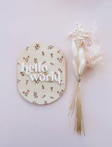 Oval “hello world” baby announcement plaque - floral