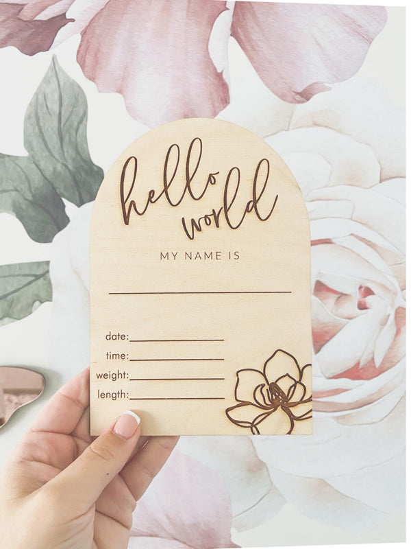 "Hello world" arch announcement plaque with magnolia flower