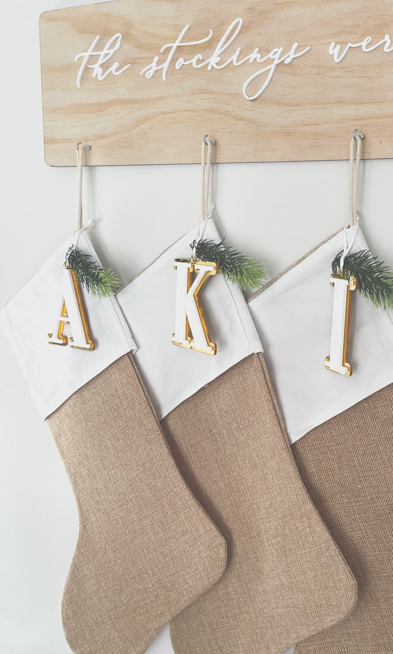 Natural burlap Christmas stocking with initial tag