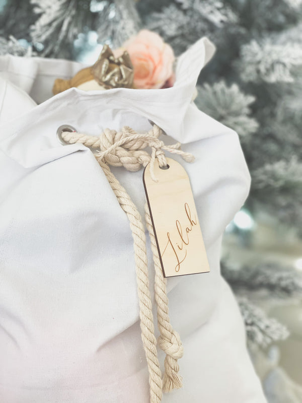 White cotton Santa sack with timber arch-shaped tag