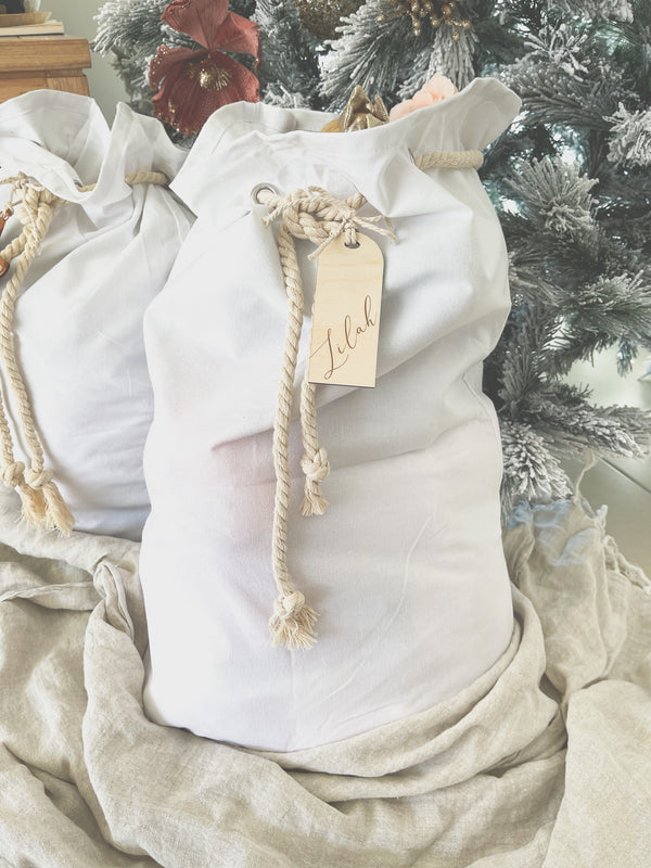White cotton Santa sack with timber arch-shaped tag