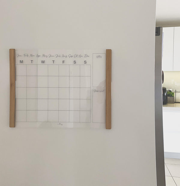 Velcro-mounted acrylic monthly planner with bamboo accents