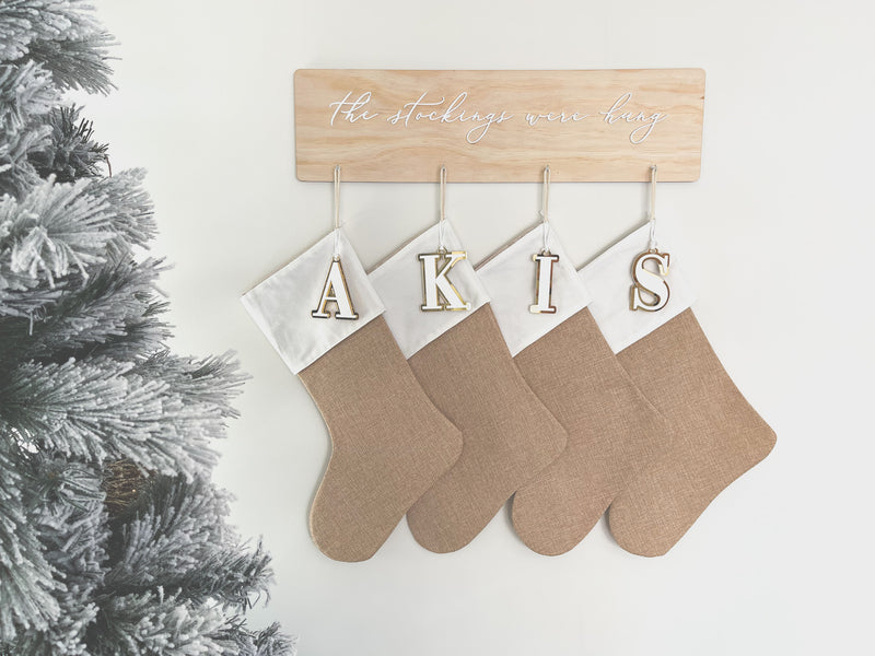 Natural burlap Christmas stocking with initial tag